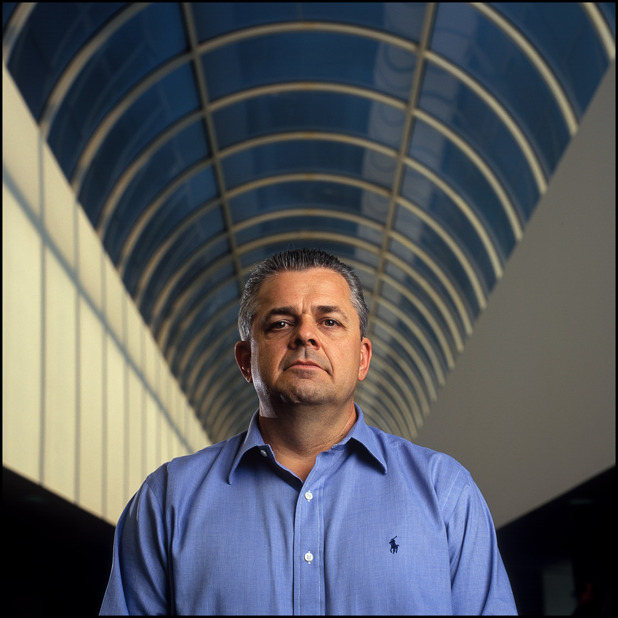 A business portrait of a CIO in a large office atrium.