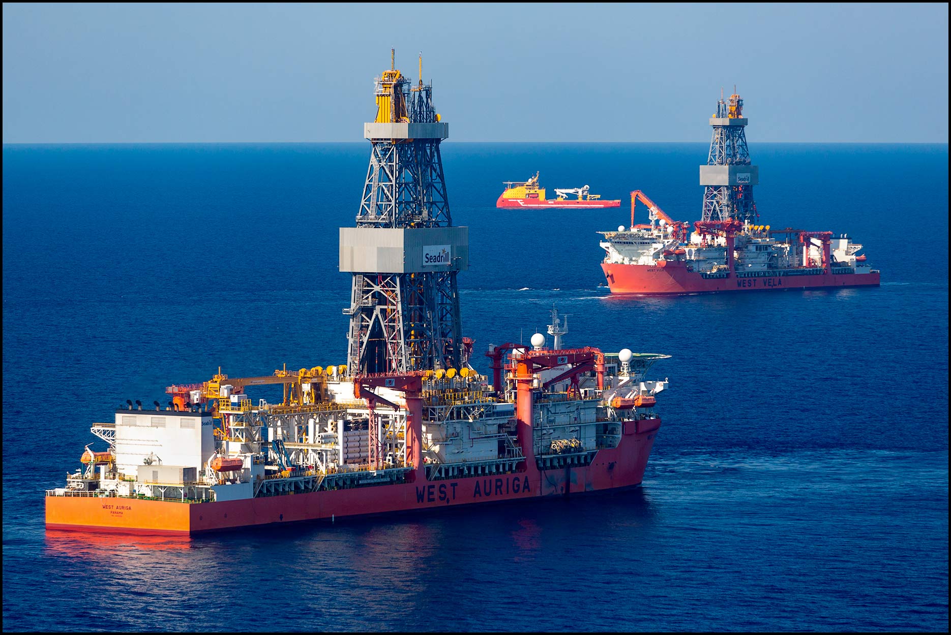 Aerial Of Two Large Drill Ships In The Calm Waters Of The Gulf Of Mexico.